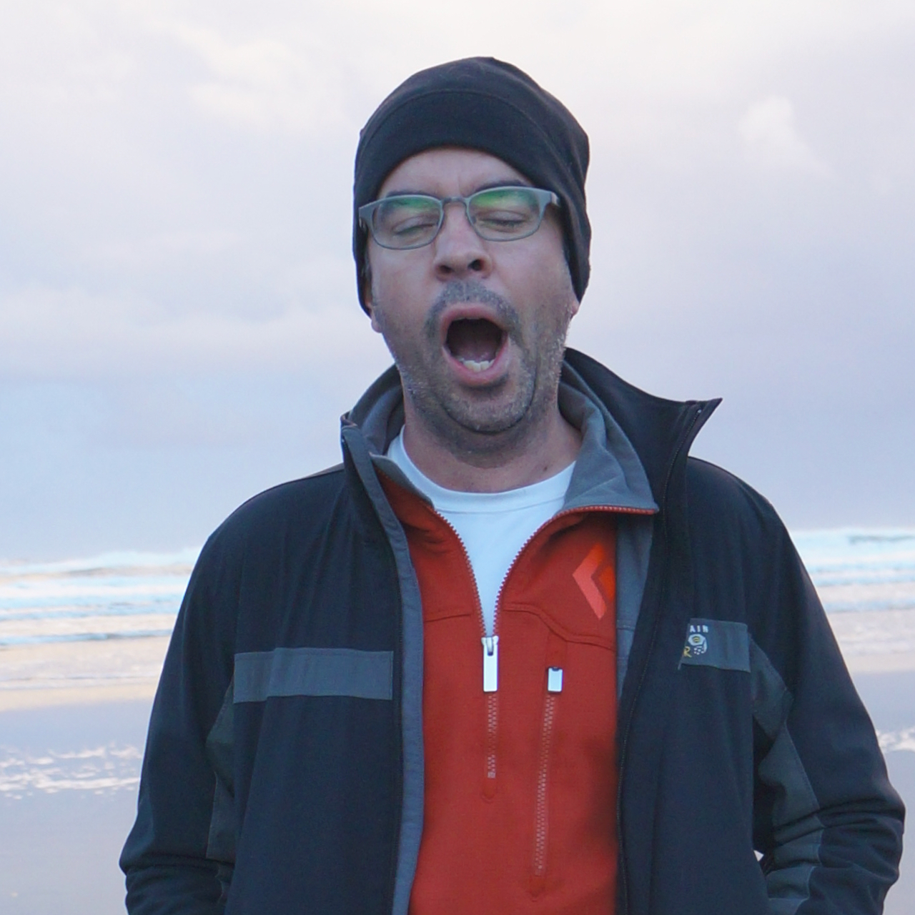 A picture of me, your author, yawning on the beach.